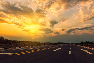 Picturesque landscape scene and sunrise above road.