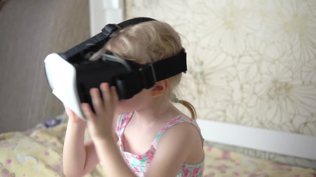 Little girl uses virtual reality glasses