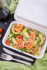 Classical combination of a salmon and avocado to salad iceberg, arugula and cheese parmesan