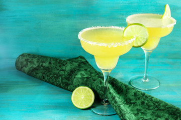 Lemon Margarita cocktails with limes and copyspace