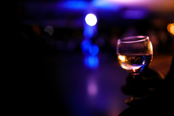 Reflection of the crowd in glass of wine