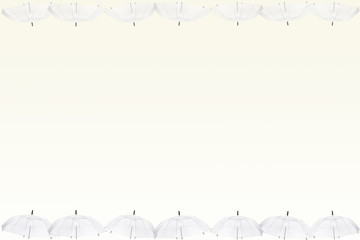 Transparent umbrella on light yellow background.