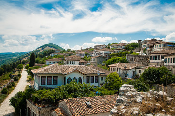 Fototapeta na wymiar 2016 Albania Berat - City of thousand windows, beautifull view of town on the hill between a lot of trees and blue sky
