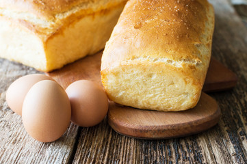 bread baked in the oven and eggs on the table