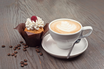 Coffee cappuccino and dessert on wooden table