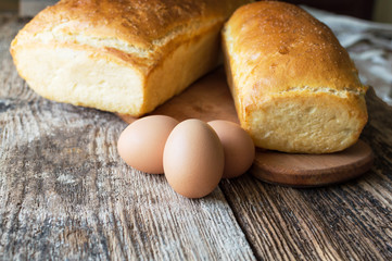 bread baked in the oven and eggs on the table