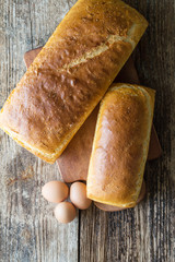 bread baked in the oven and eggs on the table