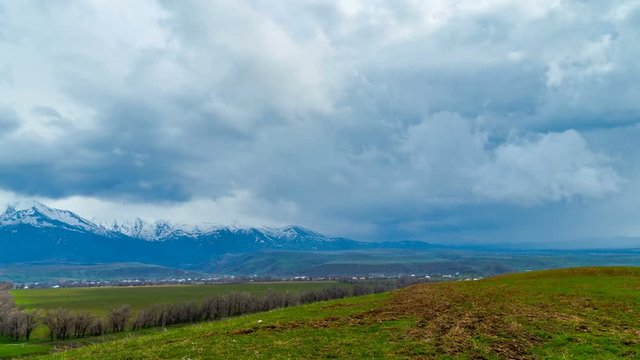 4K Timelapse. Winter clouds above the spring fields, foothills of the western Tien shan.