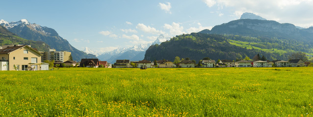 Small towns in Europe. Brunnen. Switzerland. Panorama of the town of Brunnen. Traditional Alpine meadows with luscious bright grass. Travel to Europe.