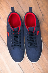 Blue sneakers on a wood background