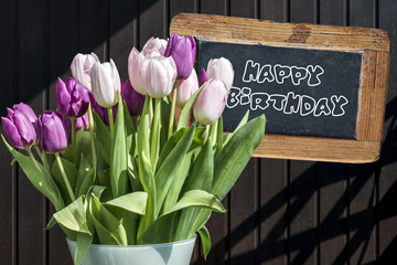 Wooden chalkboard happy birthday Sign beautiful pinktulips bucket spring flowers tulip brown background