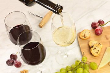 Wine, cheese, bread, and grapes at tasting