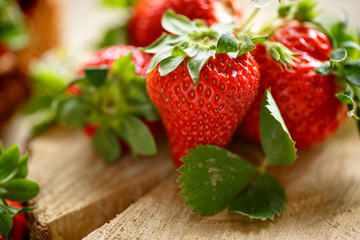 tasty red strawberries on rustic table close up.