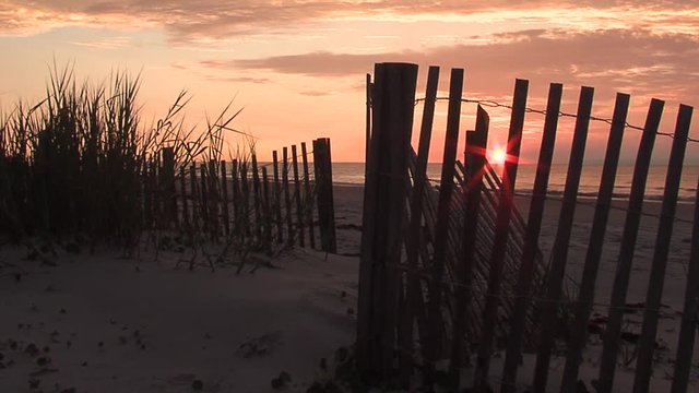Sunrise/Sunset over ocean dunes fence