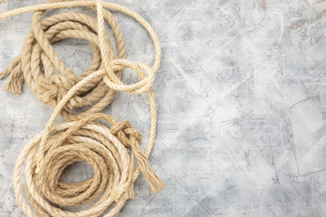 Ropes tied with knots on a gray background
