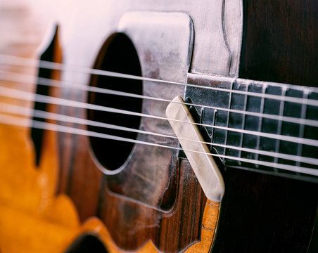 close up instrument strings and pick.