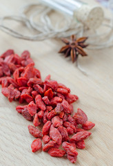 Goji berries and clove on a wooden Board.