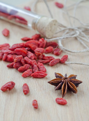 Goji berries and clove on a wooden Board.