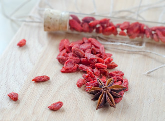 Goji berries and clove on a wooden Board.