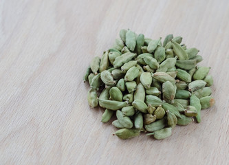 Dry aroma cardamon on the wooden board