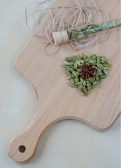Dry aroma cardamon on the wooden board