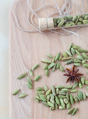 Dry aroma cardamon on the wooden board