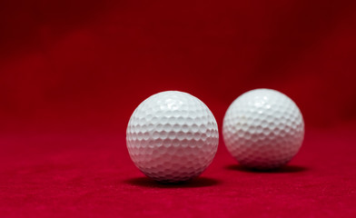 Two golf ball and red flannel background