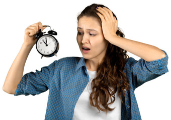 Young woman holding alarm clock