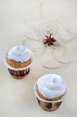 Cakes with cream on wooden board