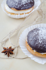 Cakes with chocolate and coconuts decorated with dried cloves and twine.
