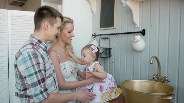 Family With Baby Having Breakfast In Kitchen Together, happy american people