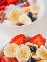 Bowl of curd with strawberry, blueberry and banana