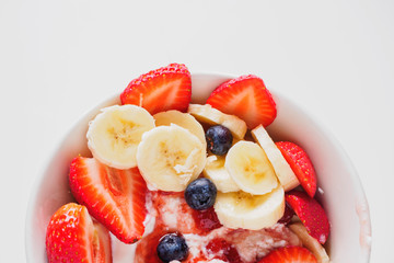 Bowl of curd with strawberry, blueberry and banana