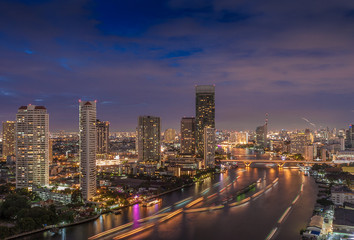 Bangkok city by the Chao Phraya river with Sathon bridge at night, Thailand