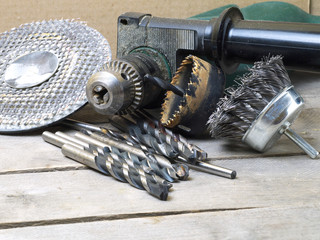 drill machine and attachments - wire brush, hole saw, grinding circle and assorted bits on wooden...