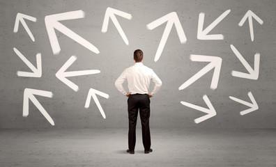 Confused salesman with arrows on wall