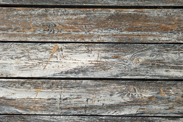 Horizontal old cracked wooden plates with horizontal gaps, planks and chinks