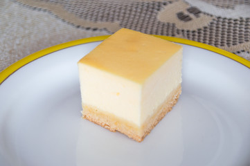 Homemade cheesecake on white plate.