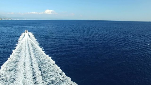 Aerial view of a maxi rib navigating fast off the Italian coast.