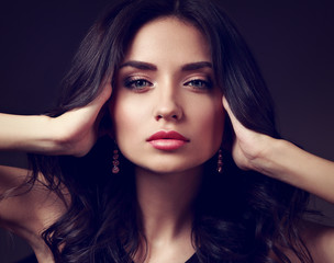 Fototapeta premium Beautiful makeup woman with pink lipstick and long curly hair looking calm. Closeup fashion portrait. Toned art