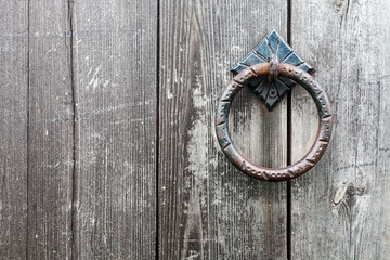 The old door handle on a wooden door