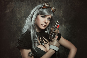 Fototapeta na wymiar Steampunk woman with mechanical gun