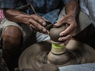 Master are molding clay to make earthenware