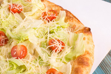 A piece of pizza of Caesar with chicken breast and cheese parmesan