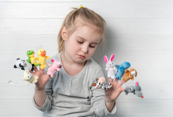 girl with doll puppets on her hands