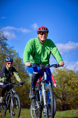 Walking a bike through the forest in the spring.