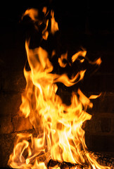 Near a flaming fire, covering all the wood