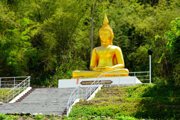 Golden stone statue of a buddha in Thailand.