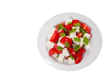 salad with cheese, tomatoes and basil. top view. isolated on white