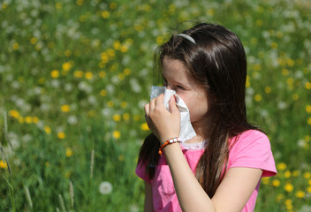Young girl with long brown hair with allergy to the grasses blow